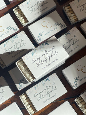 Personalized white matches with a label with the name of the bride and groom and a quote that reads: The perfect match.